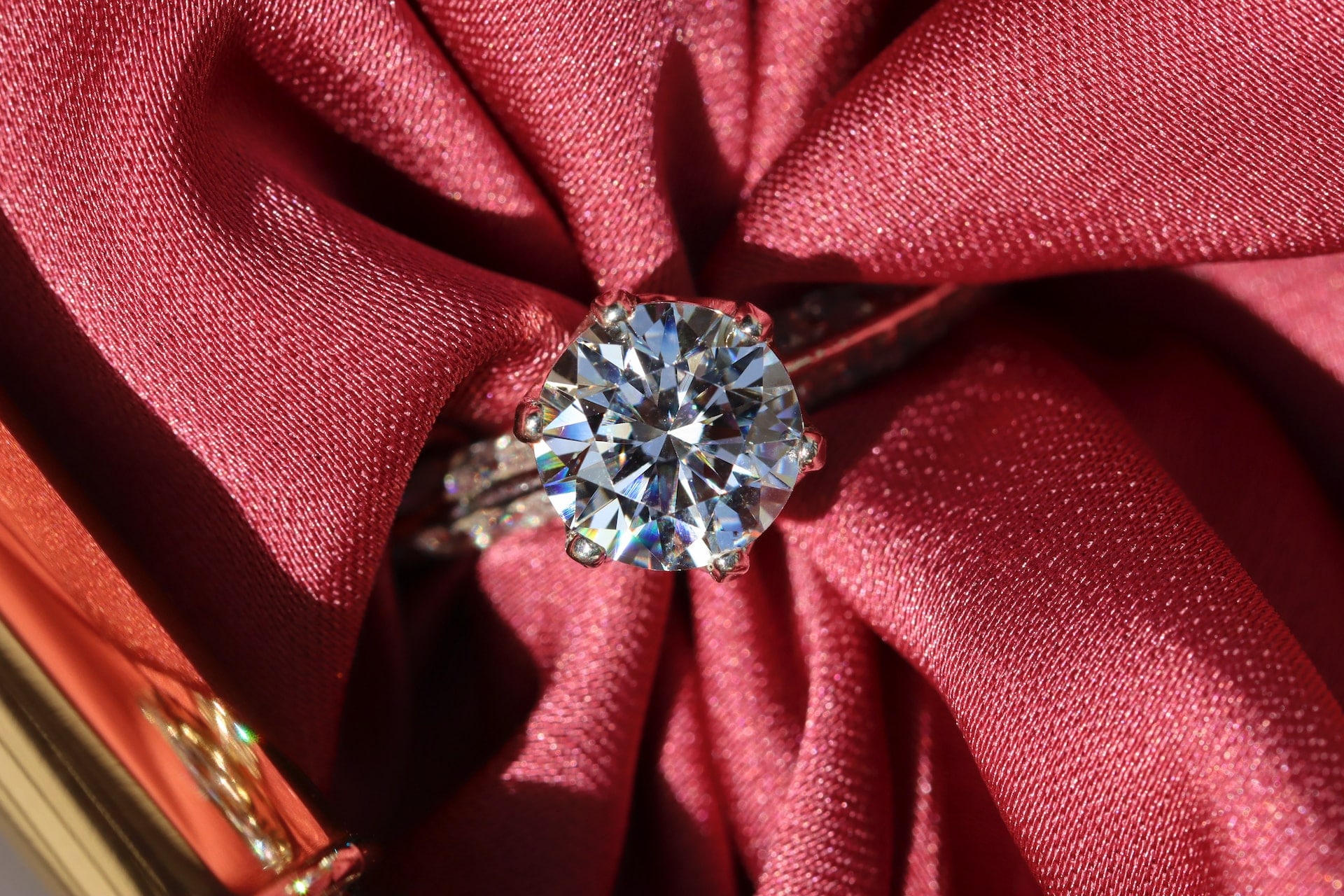diamond engagement ring wrapped around a red cloth