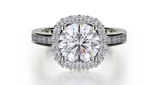 a white gold halo engagement ring with channel set side stones