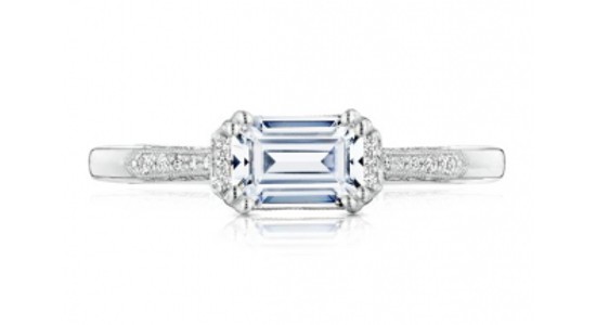 a white gold engagement ring featuring an east to west oriented emerald cut diamond