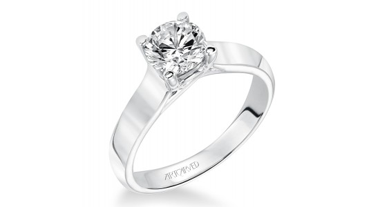 a solitaire engagement ring featuring a round cut diamond and a chunky band