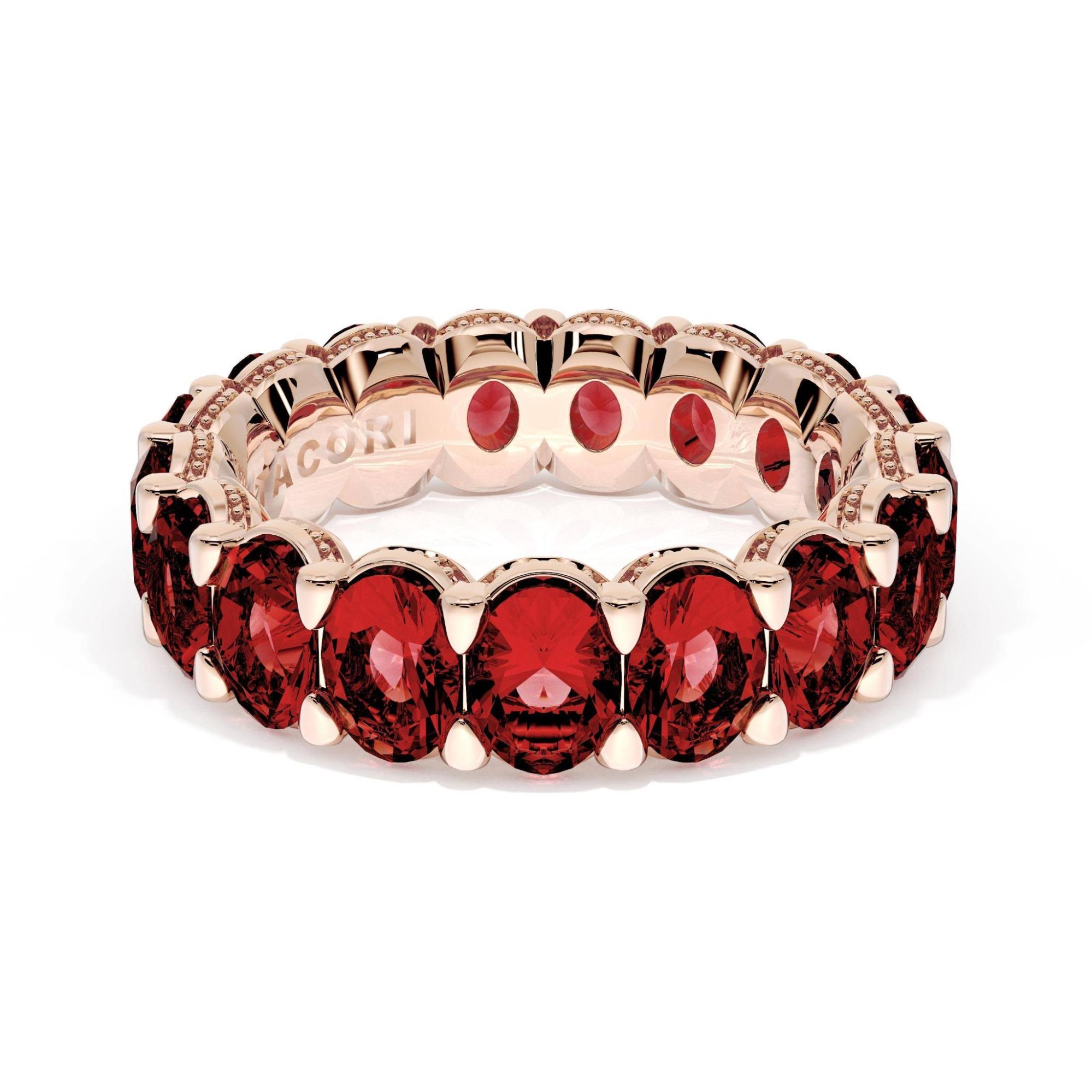 A rose gold oval cut ruby eternity band.