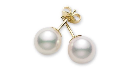 A pair of Mikimoto pearl stud earrings with yellow gold backings, available at Northeastern Fine Jewelry.