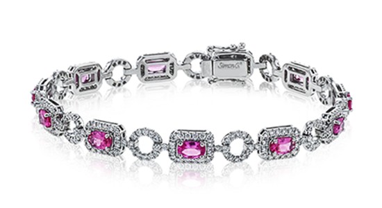 a silver and diamond bracelet by Simon G. with pink spinel gems