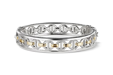 A chain bangle bracelets made from sterling silver and gold by Judith Ripka