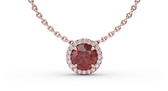 a rose gold pendant necklace featuring a round cut ruby and accent diamonds