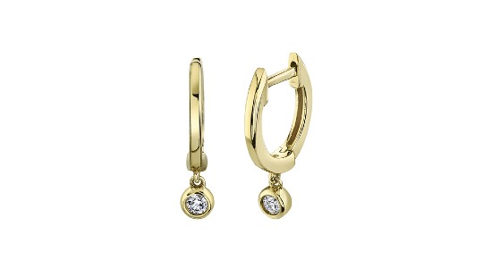 a pair of yellow gold huggie earrings with two bezel set, dangling diamonds