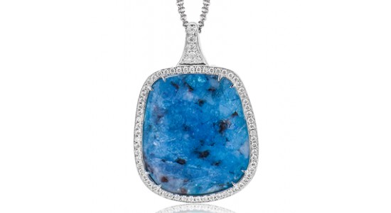 a white gold pendant necklace featuring a large blue opal surrounded by a halo of diamonds