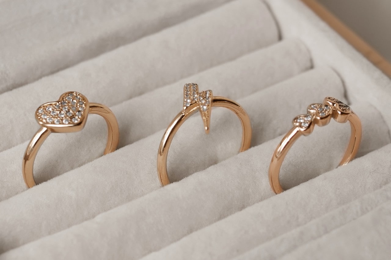 three rose gold rings nestled in a soft lined jewelry box