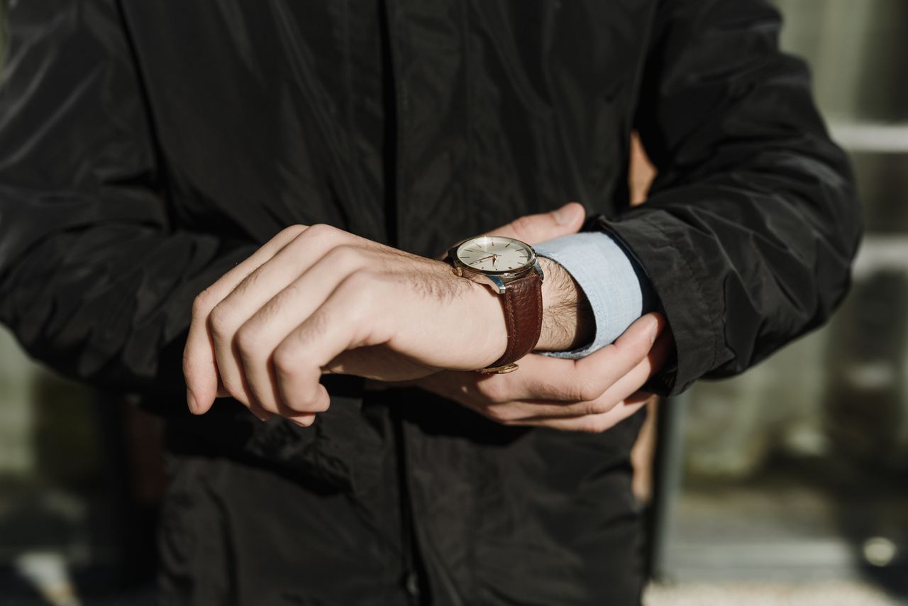 man wearing a black shirt and a watch