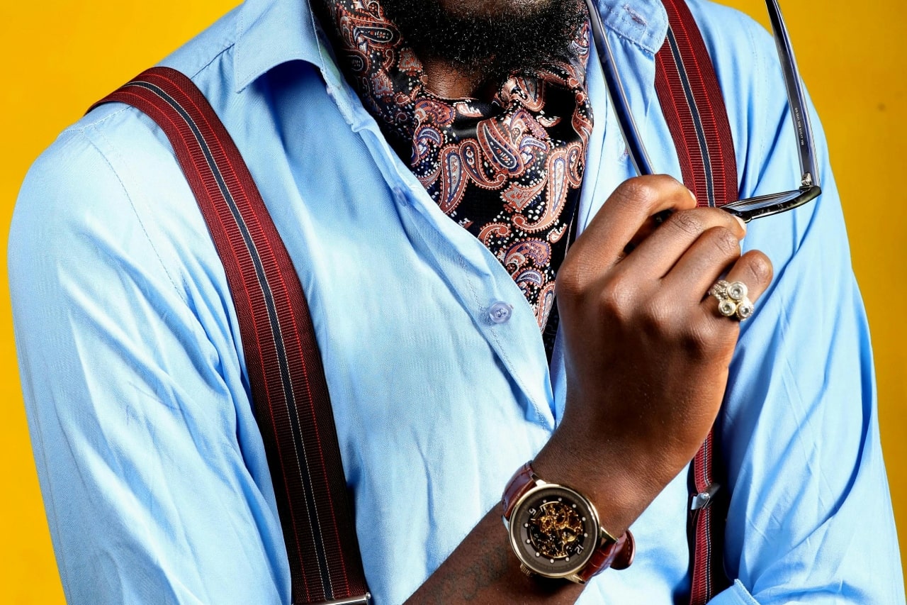 A close-up of a fashionable man wearing an elegant wrist watch.