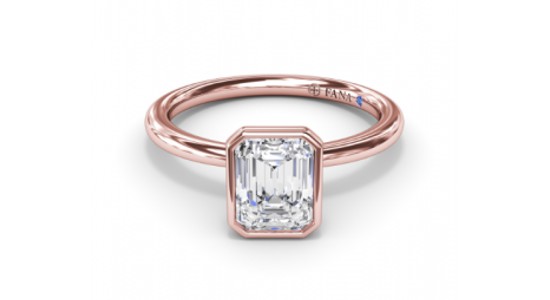 a rose gold engagement ring with a bezel set center stone