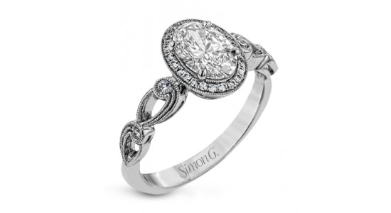 a vintage inspired engagement ring with milgrain details and flourishes