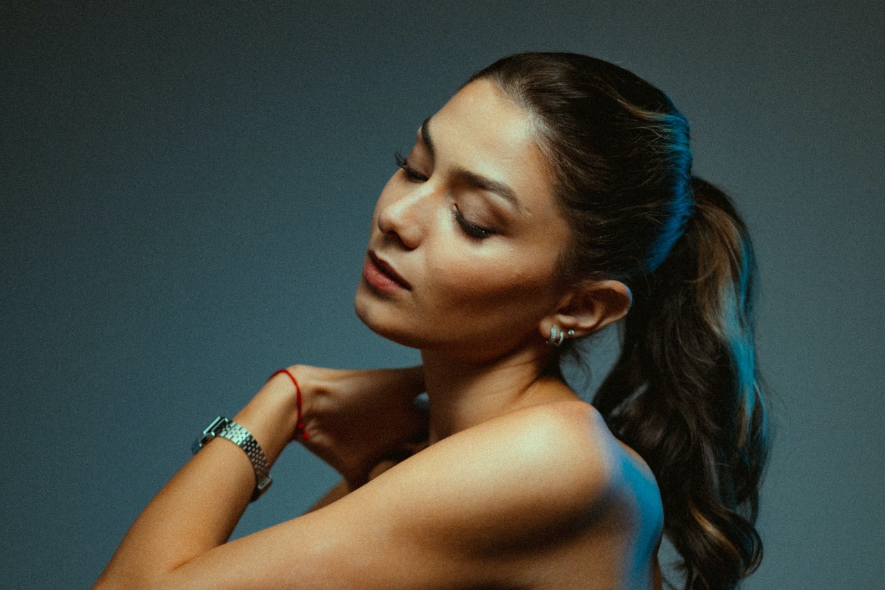 lady with her eyes closed wearing an elegant watch