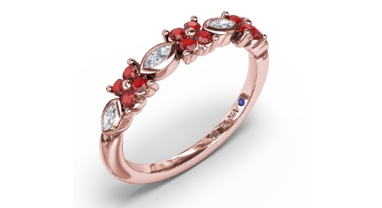a rose gold ring featuring diamonds and rubies in a floral pattern