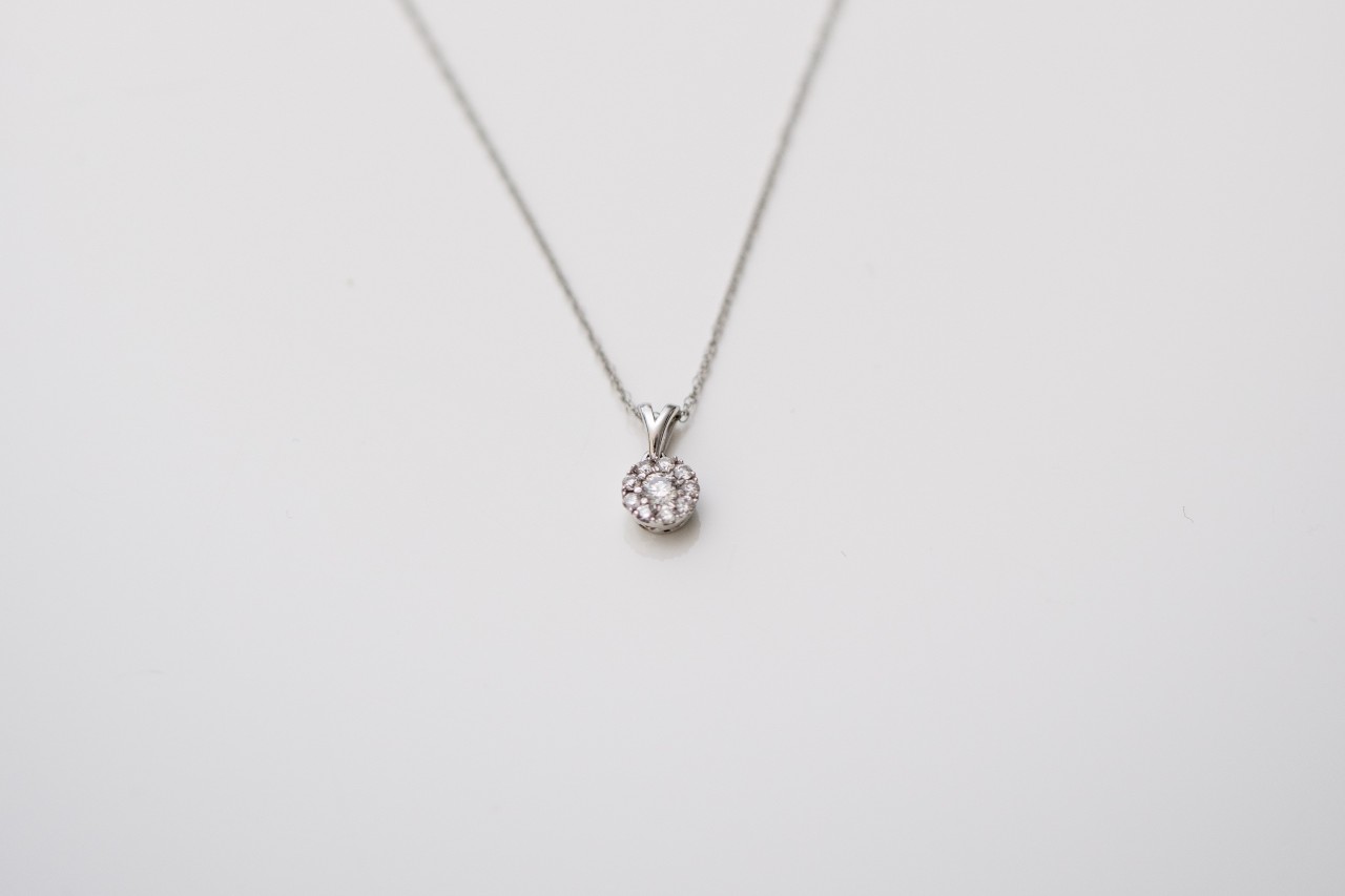 A lab-grown solitaire diamond necklace hangs from a chain.