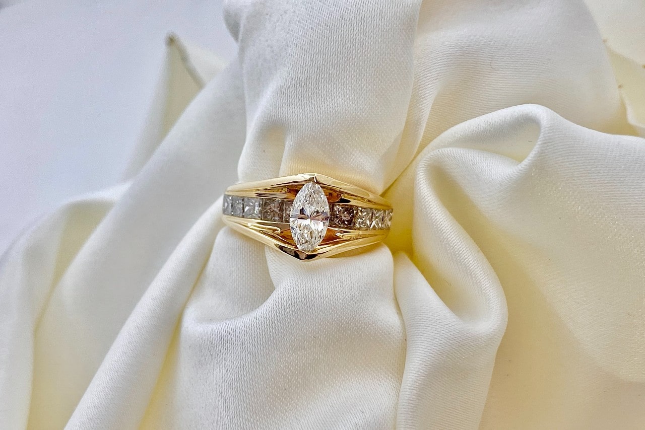 yellow gold engagement ring on a piece of white cloth